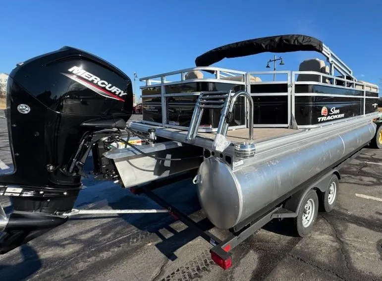 Slide: The Image of 2025 Sun Tracker SportFish 20 DLX pontoon boat with Mercury outboard engine on trailer. - 6