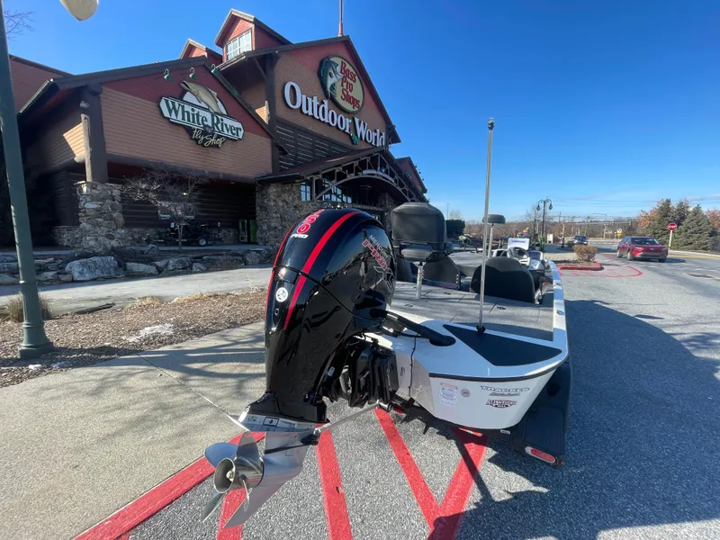 Slide: The Image of 2025 Tracker Savage 215 boat on trailer outside Bass Pro Shops. - 10