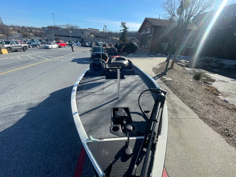 Slide: The Image of 2025 Tracker Savage 215 boat with mounted equipment in a parking lot. - 12