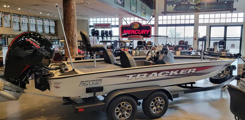 Slide: The Image of 2025 Tracker Savage 215 boat interior with fishing deck and seating in showroom. - 3