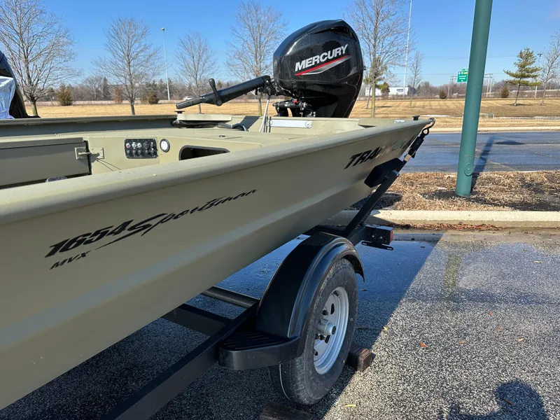 Slide: The Image of 2025 Tracker Grizzly 1654 T Sportsman boat on trailer with Mercury outboard motor. - 2