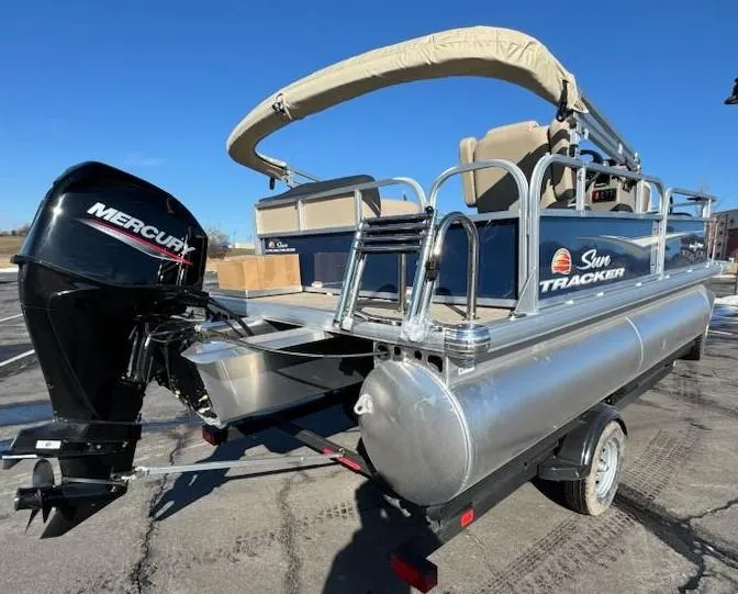 Slide: The Image of 2025 Sun Tracker Bass Buggy 16 XL Select pontoon boat with Mercury engine on trailer. - 3