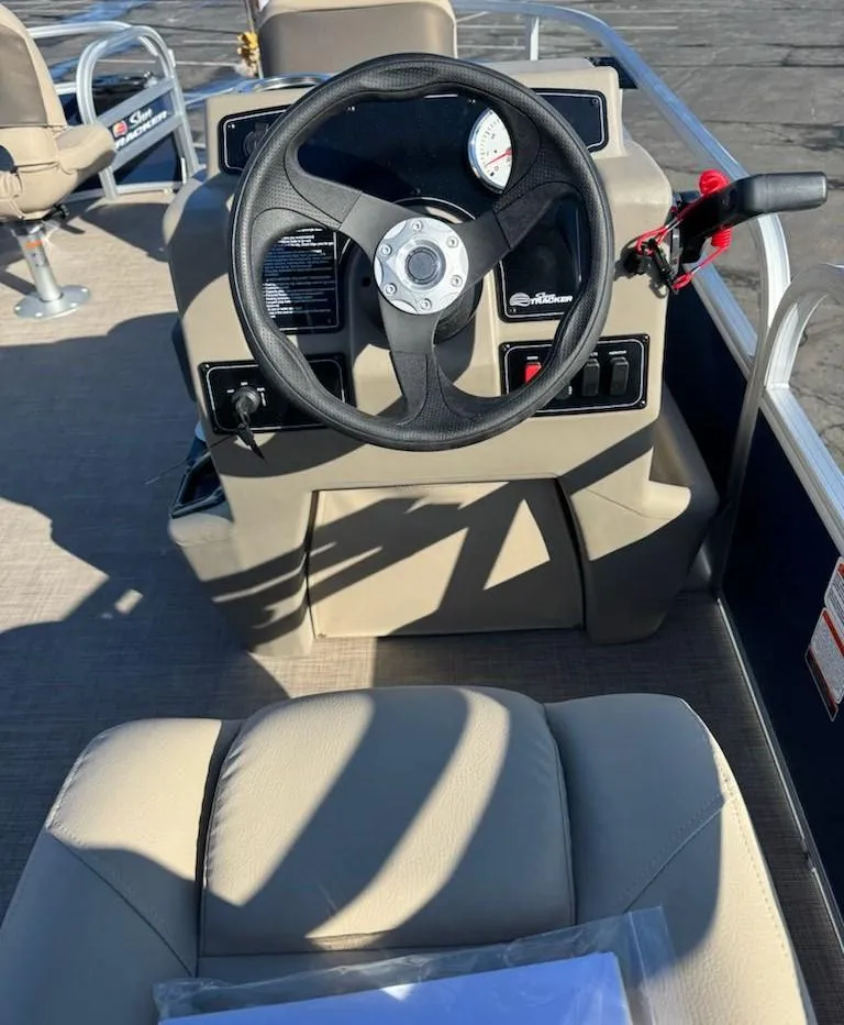 Slide: The Image of 2025 Sun Tracker Bass Buggy 16 XL Select steering console with beige seating. - 8