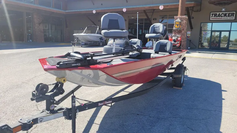 Slide: The Image of 2025 Tracker Bass Tracker Classic XL boat on trailer, parked outside dealership. - 2