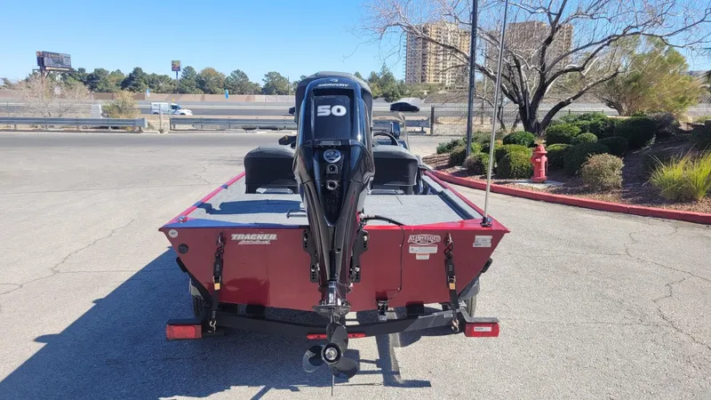 Slide: The Image of 2025 Tracker Bass Tracker Classic XL boat with 50 HP motor in a parking lot. - 4