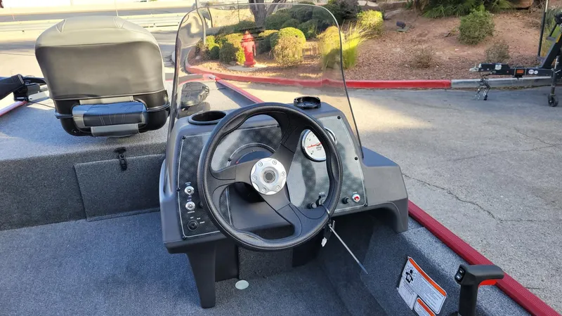Slide: The Image of 2025 Tracker Bass Tracker Classic XL boat dashboard with steering wheel and gauges. - 6