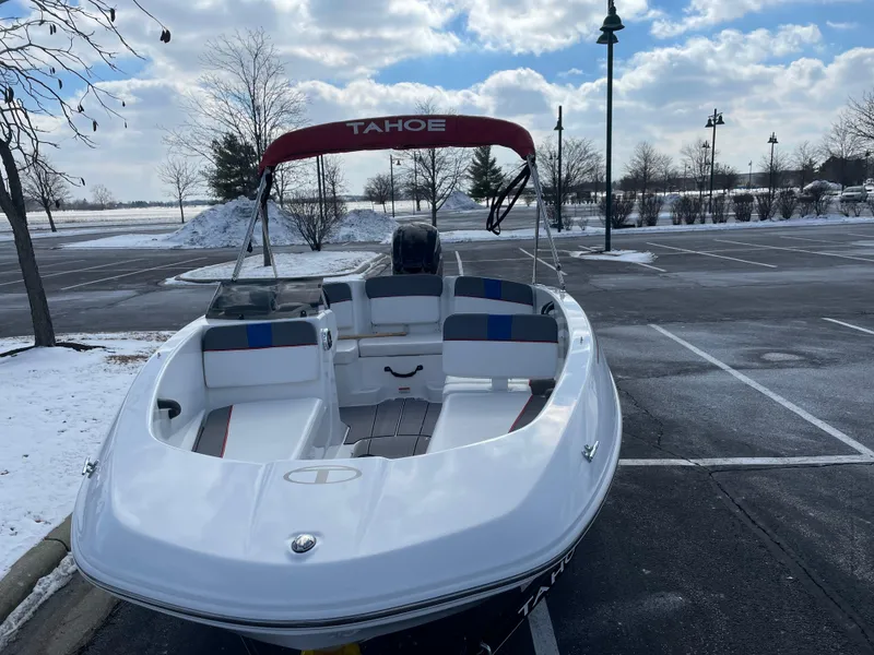 Slide: The Image of 2024 Tahoe T16 boat in snowy parking lot, under cloudy sky. - 2