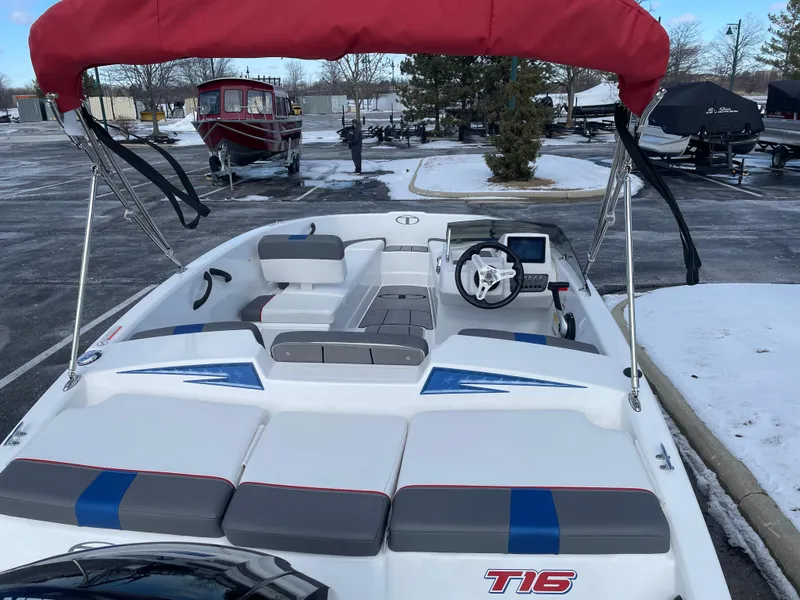 Slide: The Image of 2024 Tahoe T16 boat with red canopy in snowy parking lot. - 3
