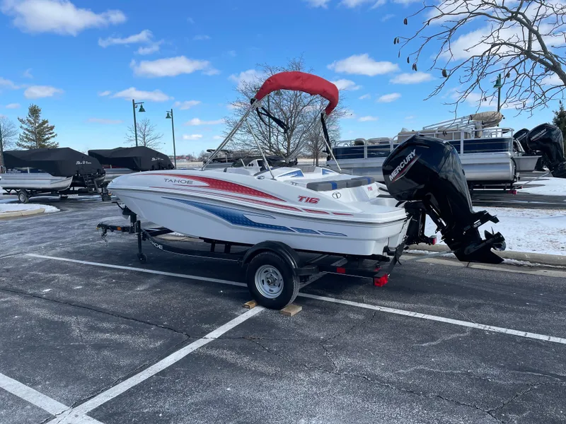 Slide: The Image of 2024 Tahoe T16 boat with outboard motor on trailer in snowy parking lot. - 4