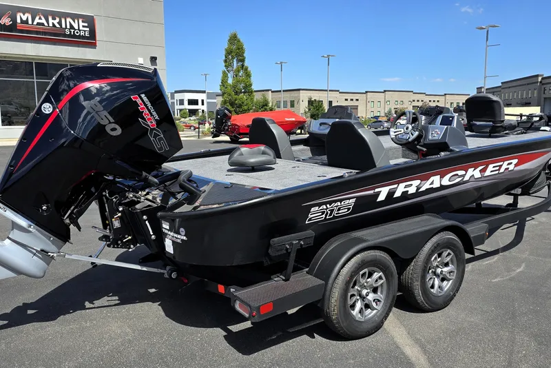 Slide: The Image of 2025 Tracker Savage 215 boat with Mercury engine at a marine store. - 87