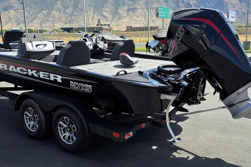 Slide: The Image of 2025 Tracker Savage 215 boat with powerful outboard motor, parked on a trailer. - 89