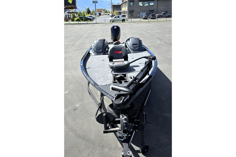Slide: The Image of 2025 Tracker Savage 215 boat on pavement, featuring modern design and equipment. - 91