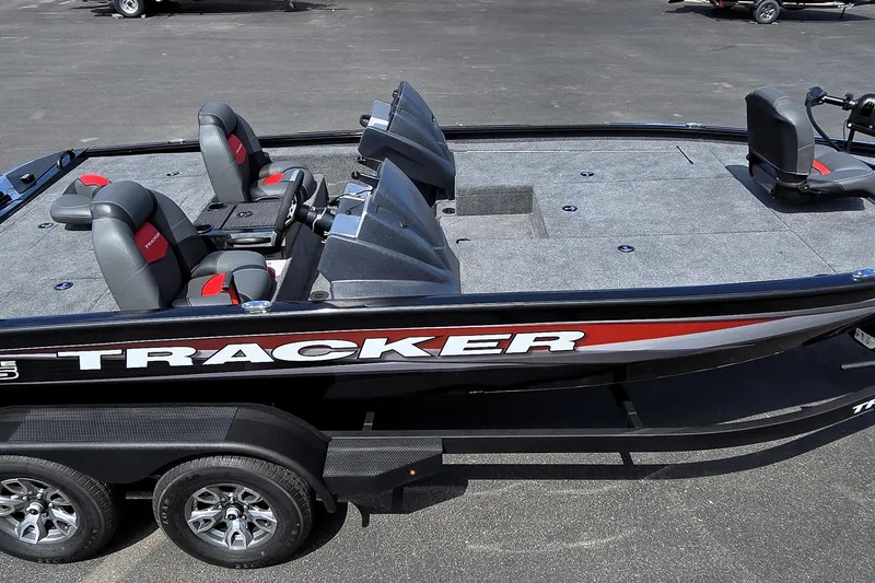Slide: The Image of 2025 Tracker Savage 215 boat with spacious seating and sleek design on a trailer. - 92