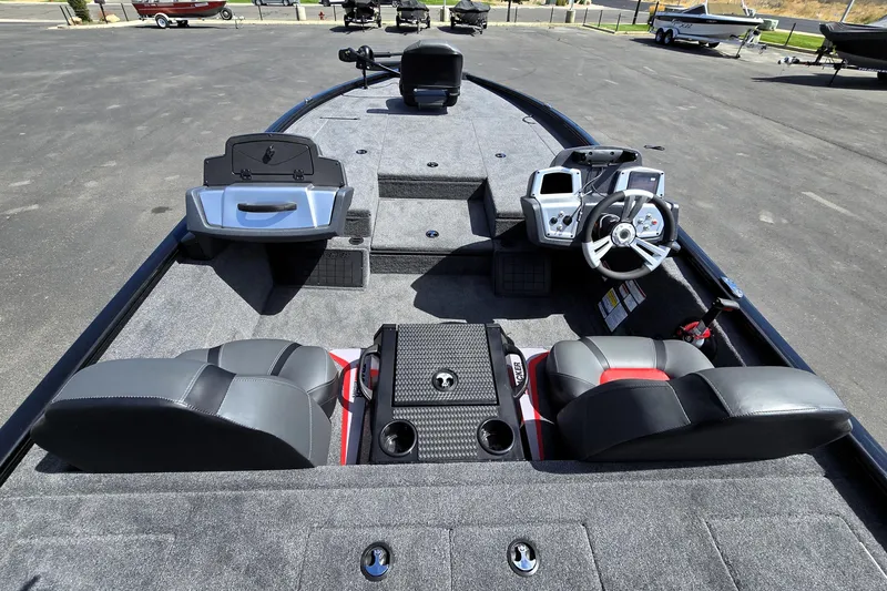 Slide: The Image of 2025 Tracker Savage 215 boat interior with dual seats, steering console, and carpeted deck. - 94