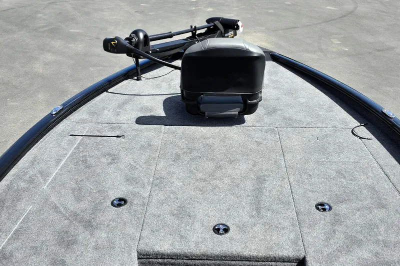 Slide: The Image of 2025 Tracker Savage 215 boat deck with trolling motor, featuring spacious carpeted surface. - 96