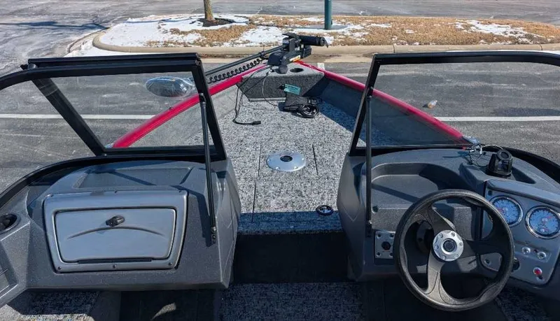 Slide: The Image of 2025 Tracker Pro Guide V-16 WT boat interior with steering wheel and dashboard. - 2