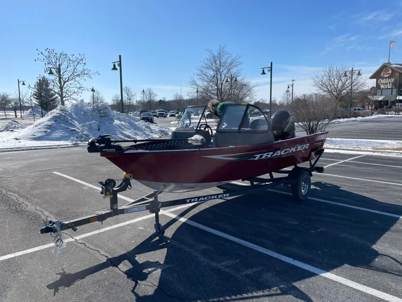 Slide: The Image of 2025 Tracker Pro Guide V-16 WT boat on trailer in snowy parking lot. - 5