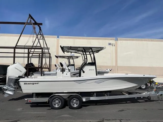The Image of 2025 Ranger 2510 Bay boat on trailer, parked outdoors, side view. - 0