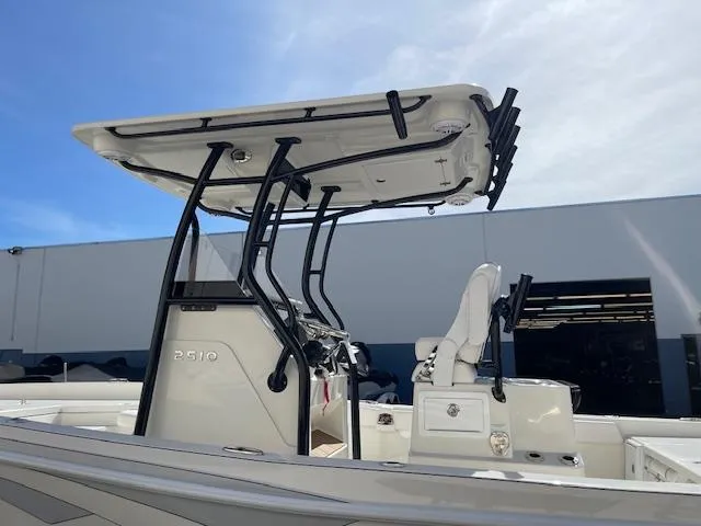 Slide: The Image of 2025 Ranger 2510 Bay boat with T-top and console, side view. - 12