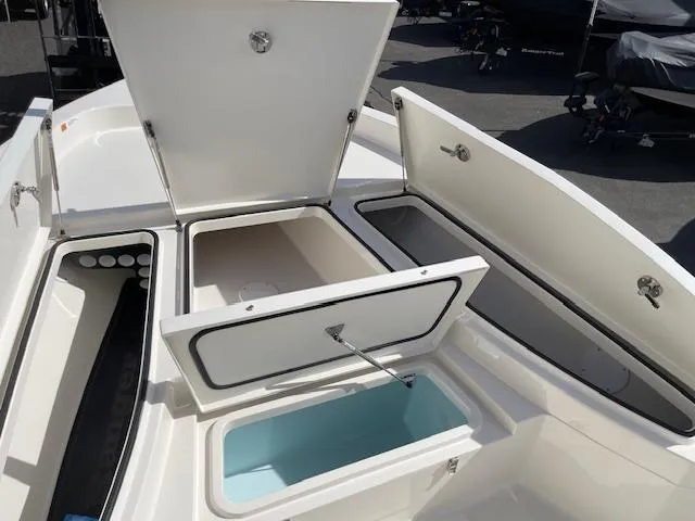 Slide: The Image of 2025 Ranger 2510 Bay boat storage compartments open, showcasing spacious interior design. - 13