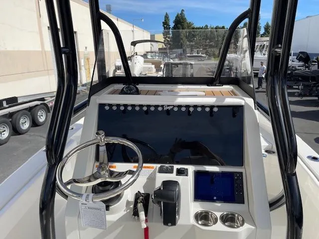 Slide: The Image of 2025 Ranger 2510 Bay boat dashboard with steering wheel and navigation controls. - 14