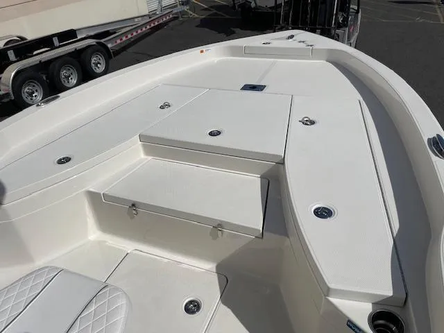 Slide: The Image of 2025 Ranger 2510 Bay boat deck with seating and storage compartments. - 16