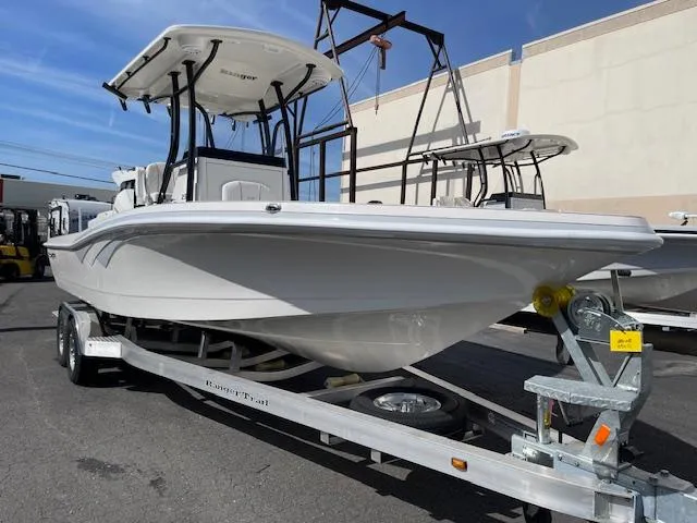 Slide: The Image of 2025 Ranger 2510 Bay boat on trailer, parked outdoors, with clear blue sky. - 3