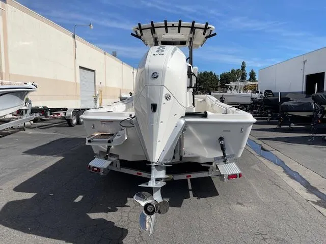 Slide: The Image of 2025 Ranger 2510 Bay boat on trailer, parked outdoors, rear view. - 5