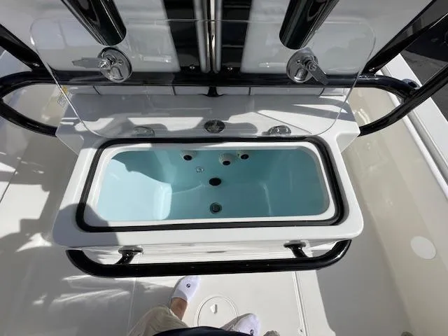 Slide: The Image of 2025 Ranger 2510 Bay boat livewell with open lid, showcasing interior features. - 7