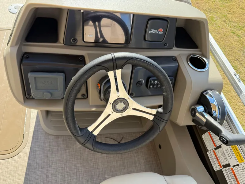 Slide: The Image of 2025 Sun Tracker SportFish 22 XP3 steering console with modern controls and dashboard. - 3