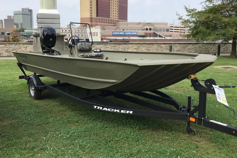 The Image of 2025 Tracker Grizzly 2072 CC boat on trailer, parked on grass, urban background. - 0
