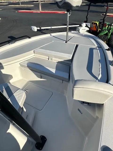 Slide: The Image of 2023 Ranger 2510 Bay boat interior with cushioned seating and fishing equipment. - 11