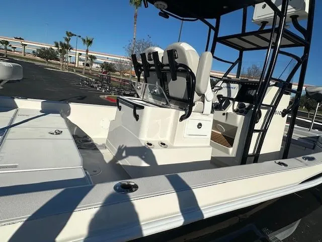 Slide: The Image of 2023 Ranger 2510 Bay boat interior with seating and console, parked outdoors. - 6