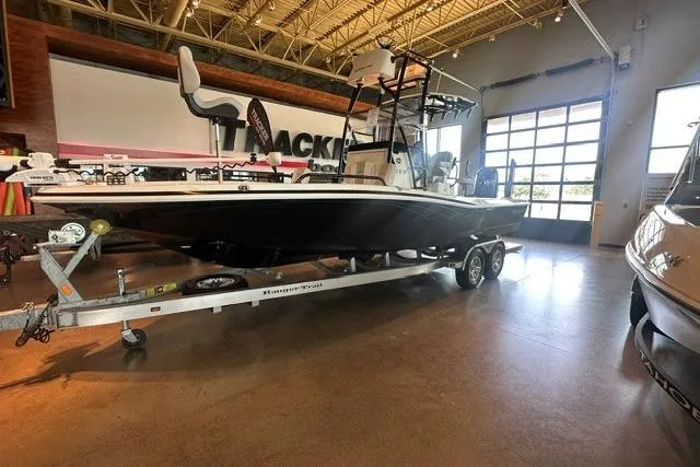 Slide: The Image of 2023 Ranger 2510 Bay boat on trailer in showroom, featuring sleek design and modern amenities. - 7