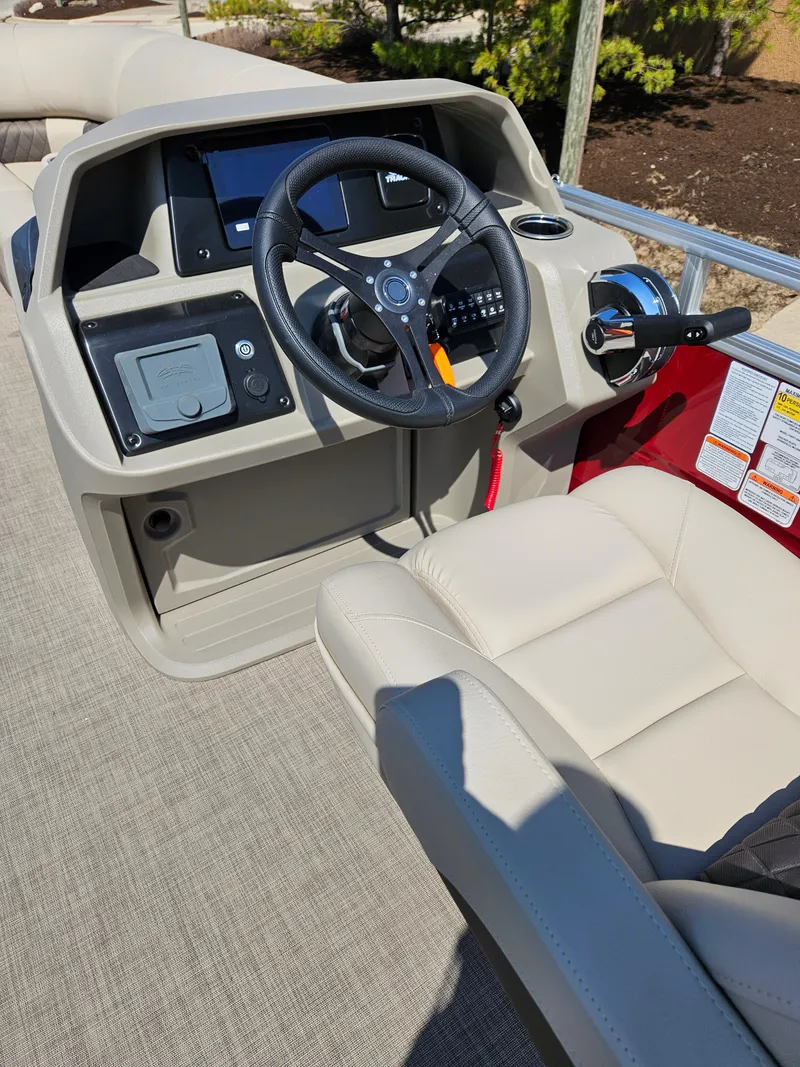 Slide: The Image of 2025 Sun Tracker Party Barge 20 DLX helm with steering wheel and controls. - 2