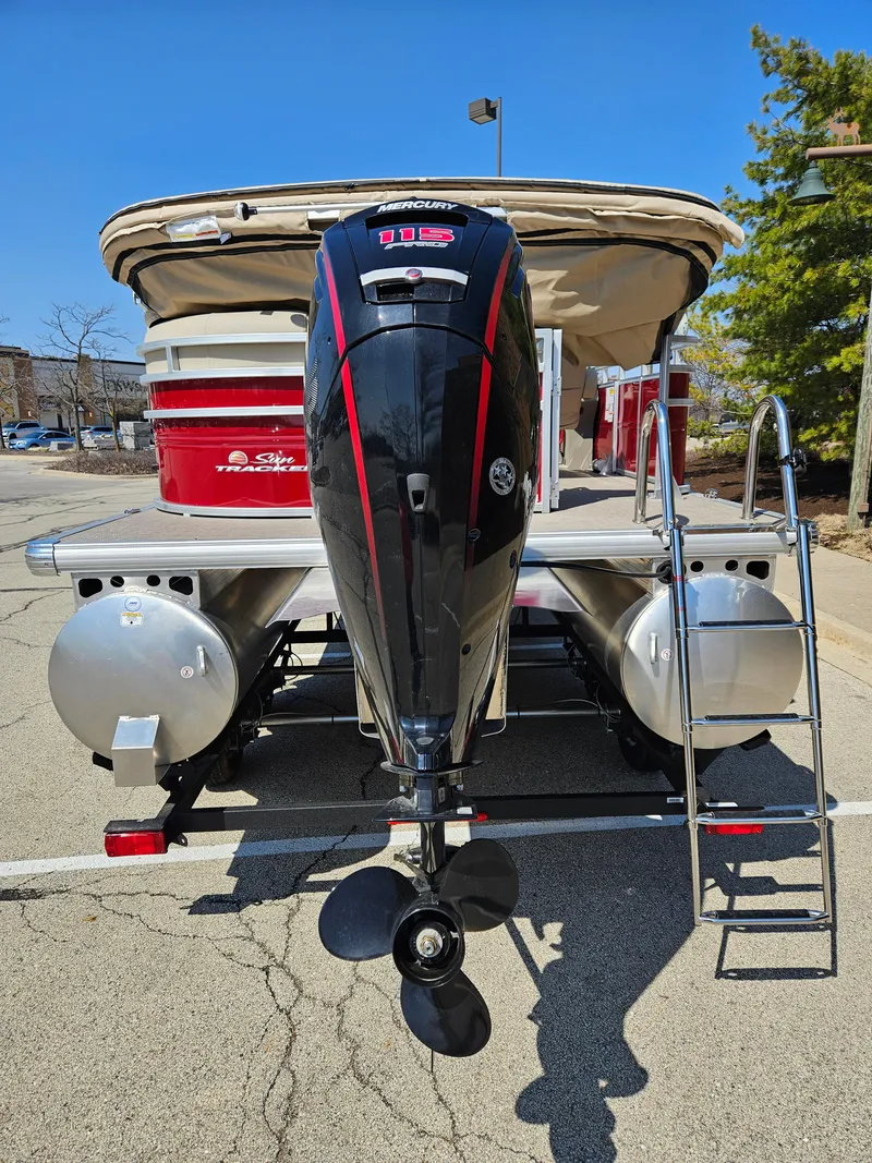 Slide: The Image of 2025 Sun Tracker Party Barge 20 DLX pontoon boat with powerful outboard motor. - 4