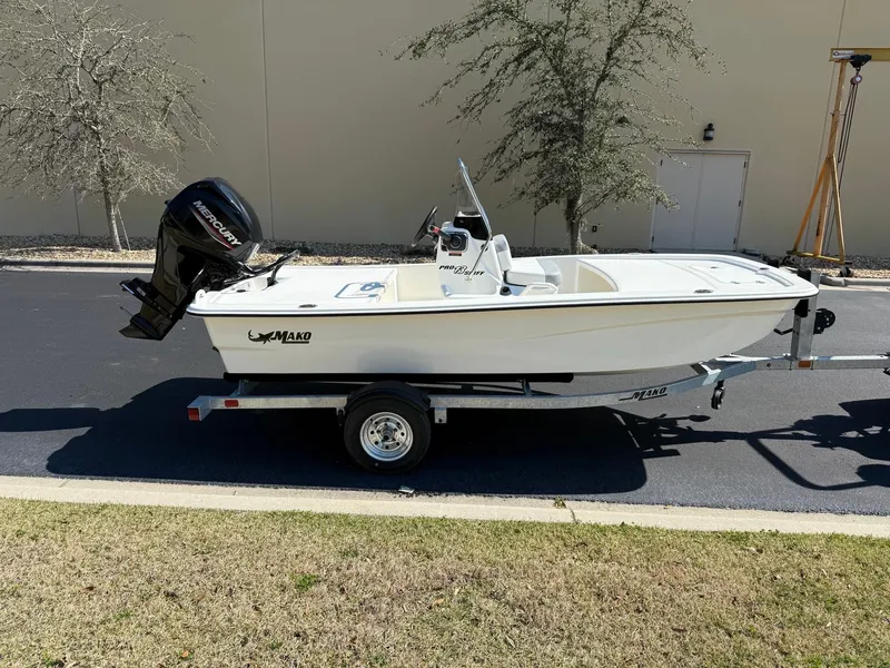 The Image of 2025 Mako Pro Skiff 13 CC boat on trailer, parked outdoors. - 0