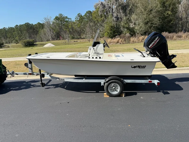 Slide: The Image of 2025 Mako Pro Skiff 13 CC boat on trailer, parked outdoors. - 3