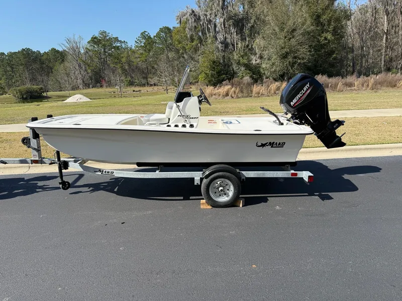Slide: The Image of 2025 Mako Pro Skiff 13 CC boat on trailer, parked outdoors. - 4