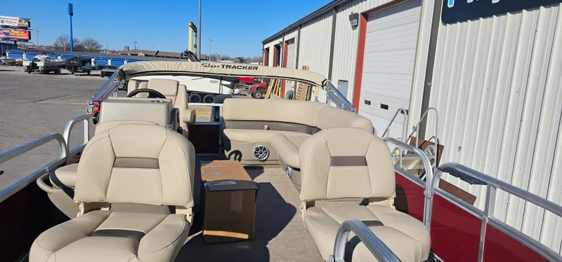 Slide: The Image of 2025 Sun Tracker Bass Buggy 16 XL Select pontoon boat with beige seating and open deck. - 4