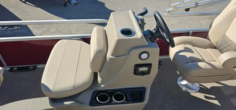 Slide: The Image of 2025 Sun Tracker Bass Buggy 16 XL Select boat interior with beige seating and steering console. - 5