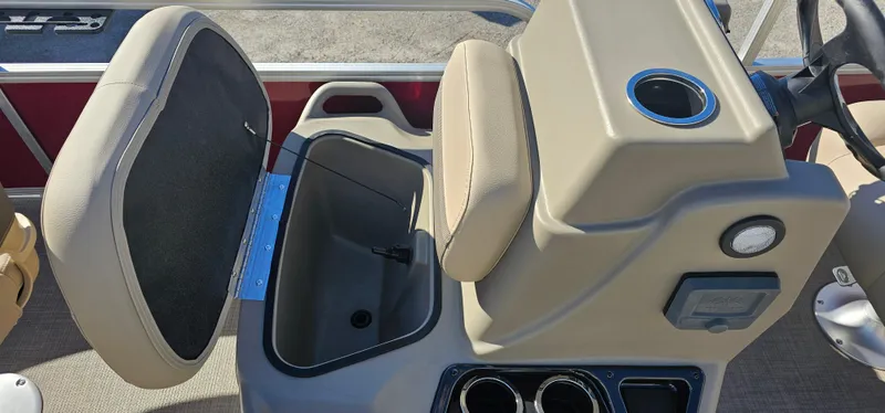 Slide: The Image of 2025 Sun Tracker Bass Buggy 16 XL Select boat console with storage compartment open. - 6