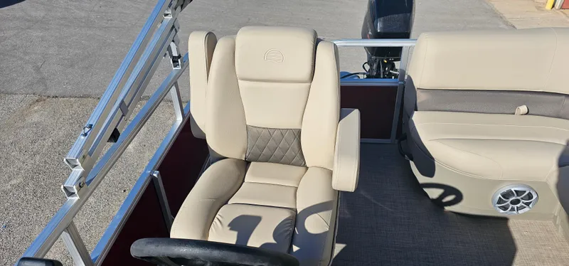 Slide: The Image of 2025 Sun Tracker Bass Buggy 16 XL Select boat interior with beige seating. - 7