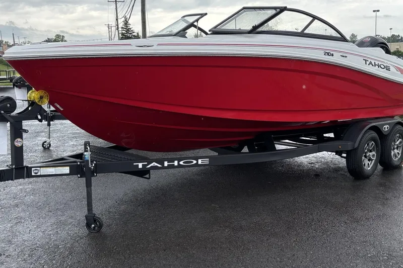 The Image of Red 2025 Tahoe 210 S boat on trailer, parked on wet pavement. - 0