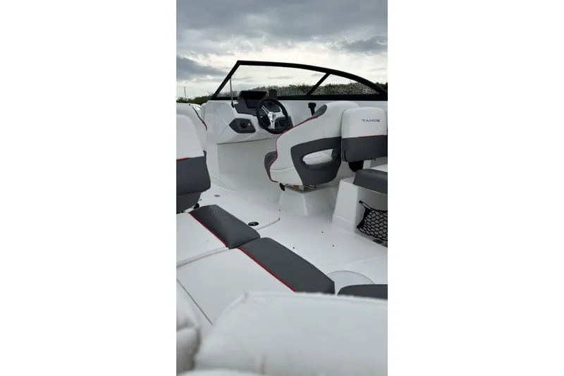 Slide: The Image of Interior view of 2025 Tahoe 210 S boat with modern seating and steering wheel. - 2
