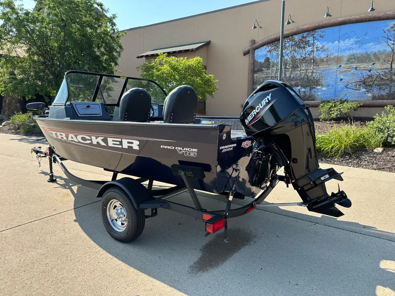 Slide: The Image of 2025 Tracker Pro Guide V-16 WT boat with Mercury engine on trailer. - 2
