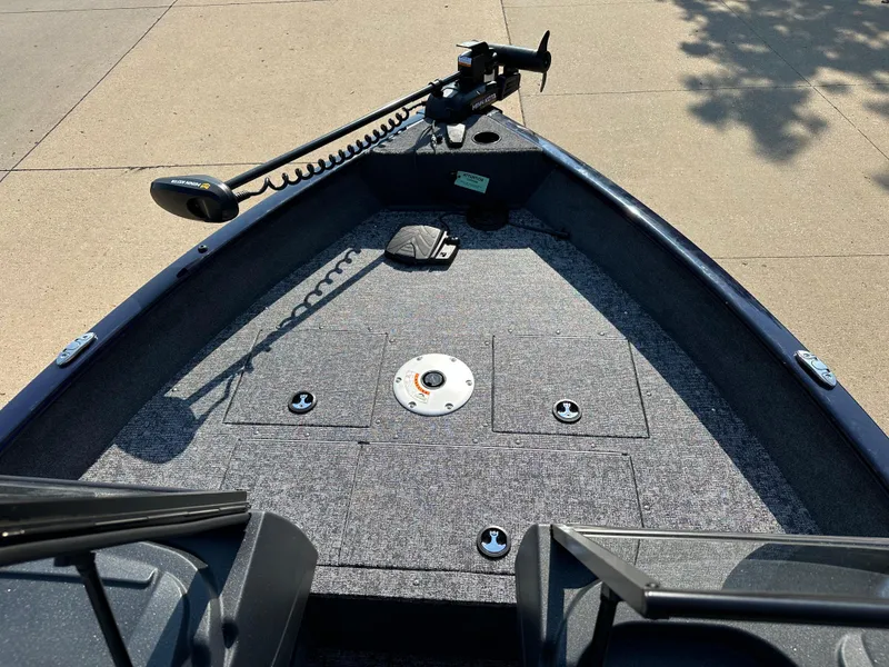 Slide: The Image of 2025 Tracker Pro Guide V-16 WT boat deck with trolling motor and storage compartments. - 3