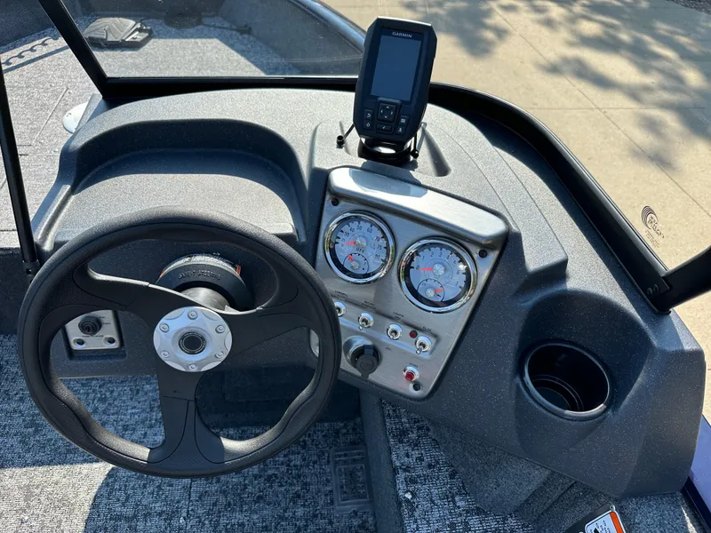 Slide: The Image of 2025 Tracker Pro Guide V-16 WT boat dashboard with steering wheel and gauges. - 5