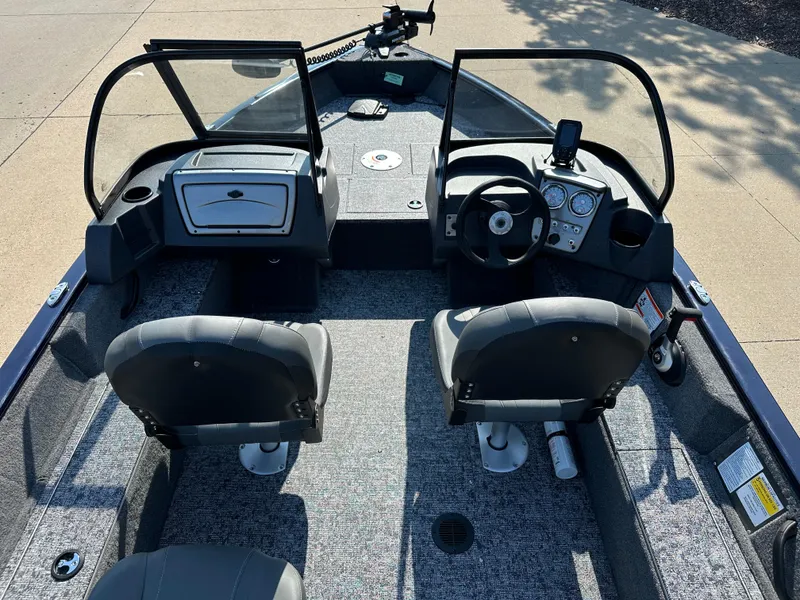 Slide: The Image of 2025 Tracker Pro Guide V-16 WT boat interior with dual seats and steering console. - 6