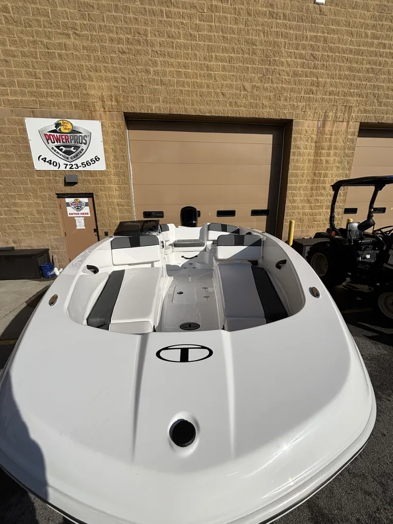 Slide: The Image of 2025 Tahoe T18 boat displayed outdoors near a garage. - 3